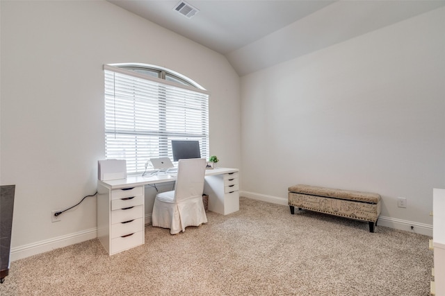 office area featuring baseboards, visible vents, vaulted ceiling, and light carpet