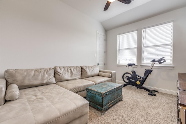 carpeted living area featuring baseboards, vaulted ceiling, and ceiling fan