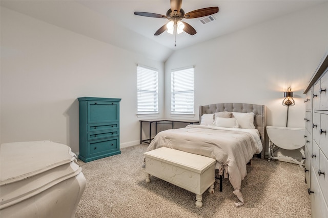 bedroom with visible vents, baseboards, a ceiling fan, light carpet, and vaulted ceiling