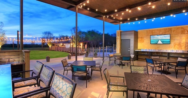 1256 Bright Stars Dr, Little Elm, TX 76227 - patio terrace at dusk with outdoor dining space