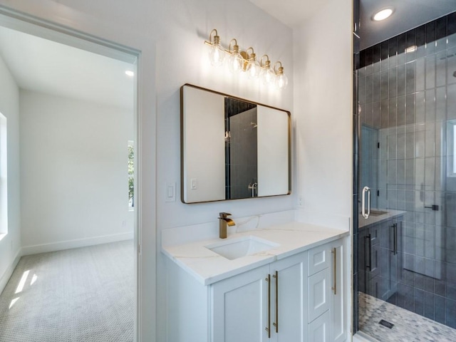 bathroom featuring a shower stall, baseboards, and vanity