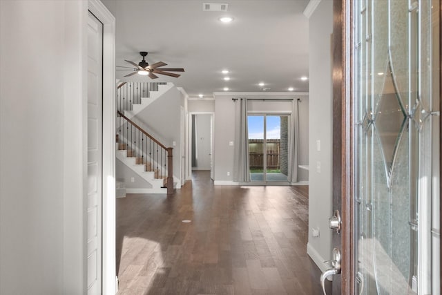 entryway with visible vents, baseboards, wood finished floors, stairs, and ceiling fan
