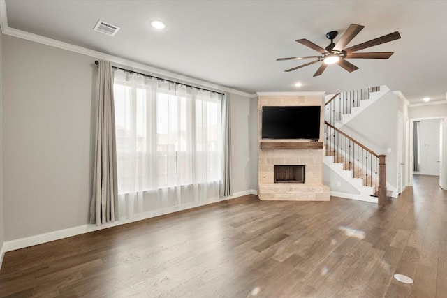 unfurnished living room with ornamental molding, visible vents, and a fireplace