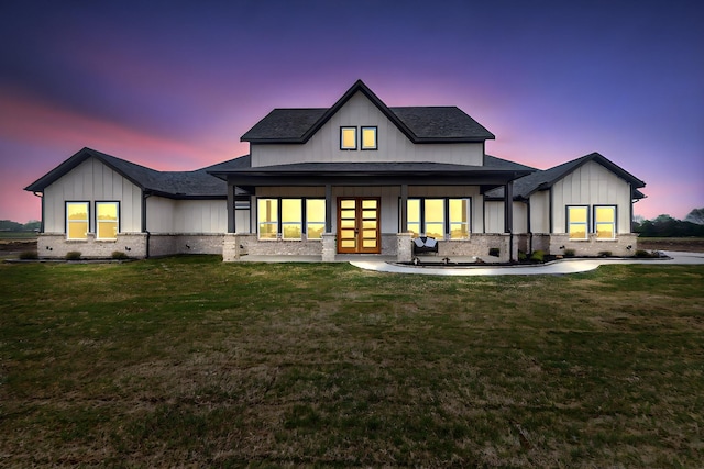 254 County Road 4615, Wolfe City, TX 75496 - back of property at dusk featuring french doors, board and batten siding, a shingled roof, and a yard