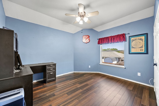 unfurnished office featuring dark wood finished floors, lofted ceiling, a ceiling fan, and baseboards