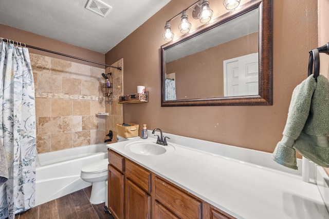 7113 Raintree Way, Denton, TX 76210 - bathroom with visible vents, vanity, wood finished floors, toilet, and shower / tub combo
