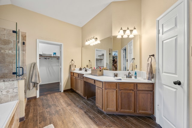 7113 Raintree Way, Denton, TX 76210 - full bath with double vanity, a spacious closet, wood finished floors, and a stall shower