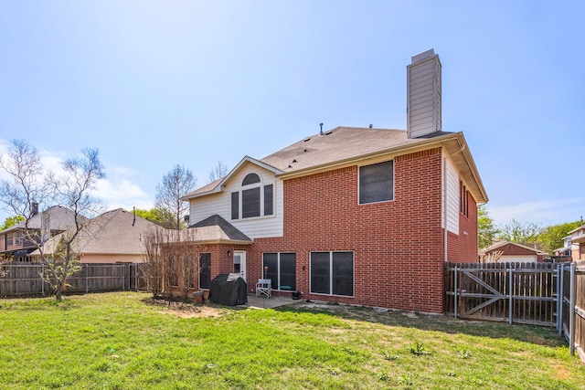 7113 Raintree Way, Denton, TX 76210 - back of house featuring a patio, a fenced backyard, a chimney, brick siding, and a yard