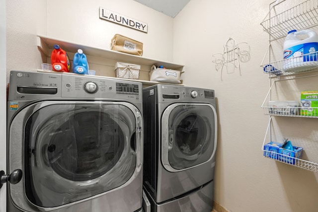laundry area with washing machine and clothes dryer and laundry area