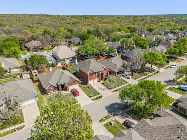 birds eye view of property with a wooded view and a residential view