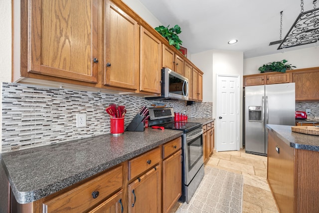 7113 Raintree Way, Denton, TX 76210 - kitchen with dark countertops, appliances with stainless steel finishes, and brown cabinetry