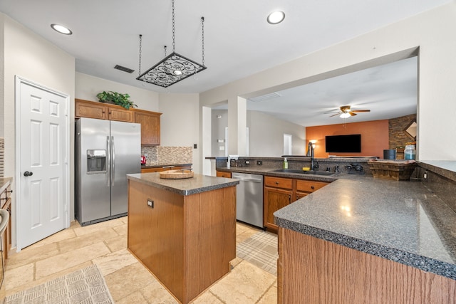 7113 Raintree Way, Denton, TX 76210 - kitchen featuring visible vents, dark countertops, ceiling fan, a sink, and stainless steel appliances