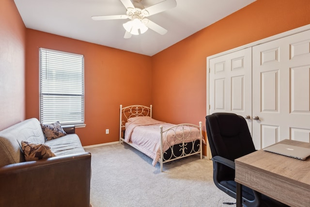 bedroom with a closet, ceiling fan, baseboards, and carpet