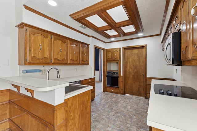kitchen with black appliances, a peninsula, brown cabinets, crown molding, and light countertops