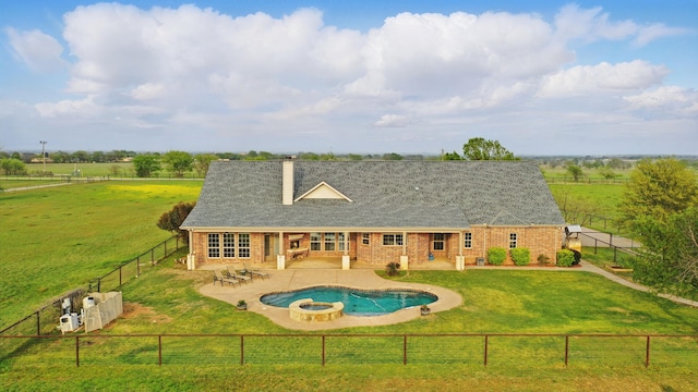 view of swimming pool with a pool with connected hot tub, a patio, a fenced backyard, a rural view, and a lawn