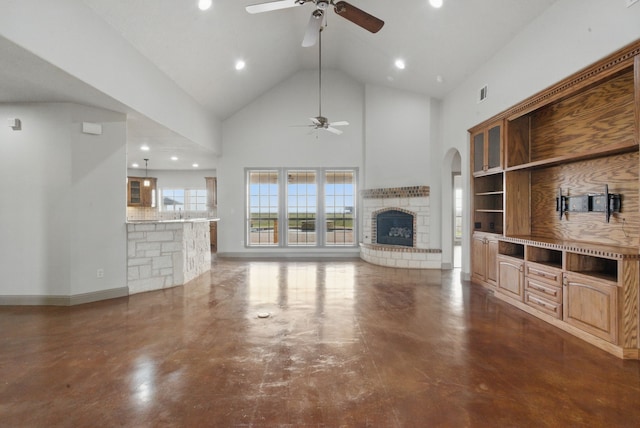 living room featuring visible vents, ceiling fan, high vaulted ceiling, and a fireplace with raised hearth