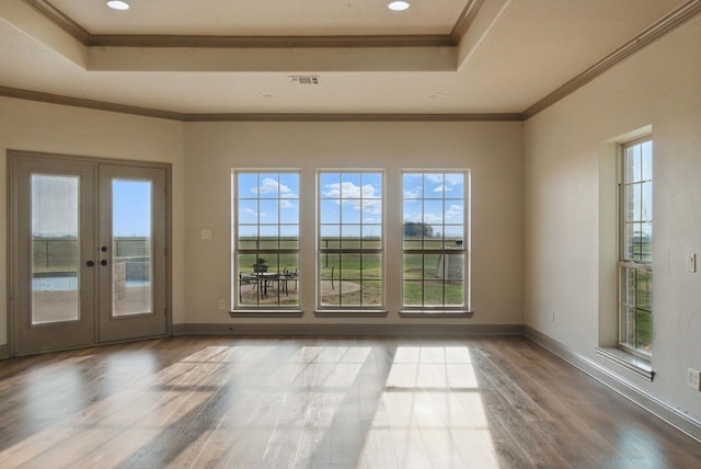 spare room featuring a tray ceiling, visible vents, french doors, and crown molding