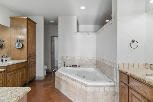 full bathroom with toilet, a jetted tub, a sink, two vanities, and concrete flooring