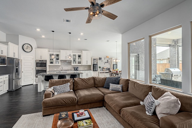 living area featuring recessed lighting, ceiling fan, dark wood finished floors, and visible vents