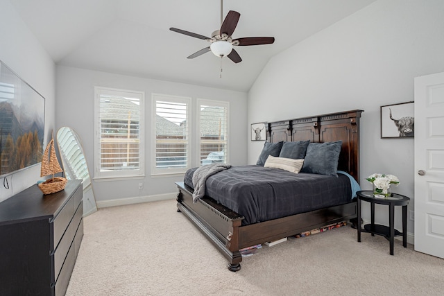 bedroom with light colored carpet, a ceiling fan, vaulted ceiling, and baseboards