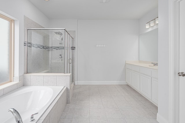 full bath featuring baseboards, a shower stall, a garden tub, and vanity