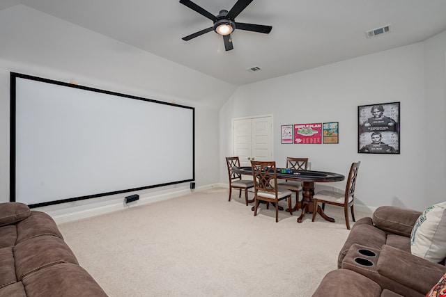 home theater room with baseboards, a ceiling fan, visible vents, and light carpet