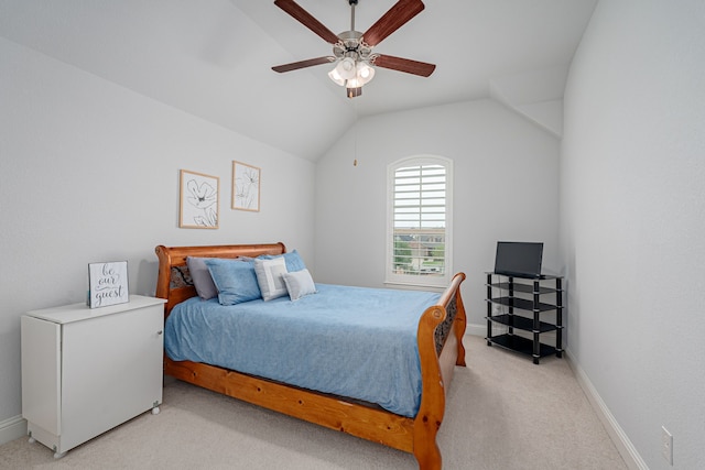 bedroom featuring light colored carpet, a ceiling fan, baseboards, and lofted ceiling