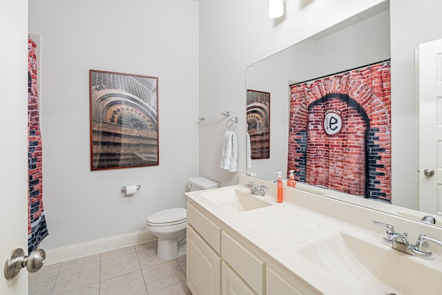 full bath featuring a sink, tile patterned floors, toilet, and double vanity