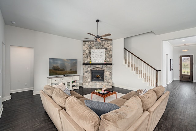 living room with baseboards, a ceiling fan, dark wood-style flooring, and stairs