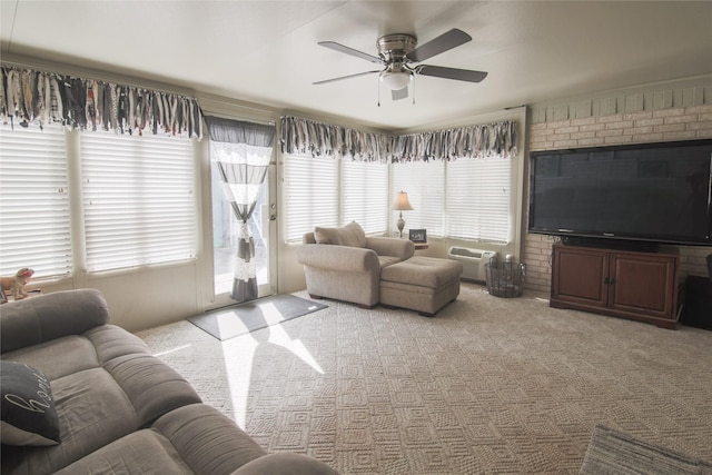 living room featuring an AC wall unit, carpet, and a ceiling fan