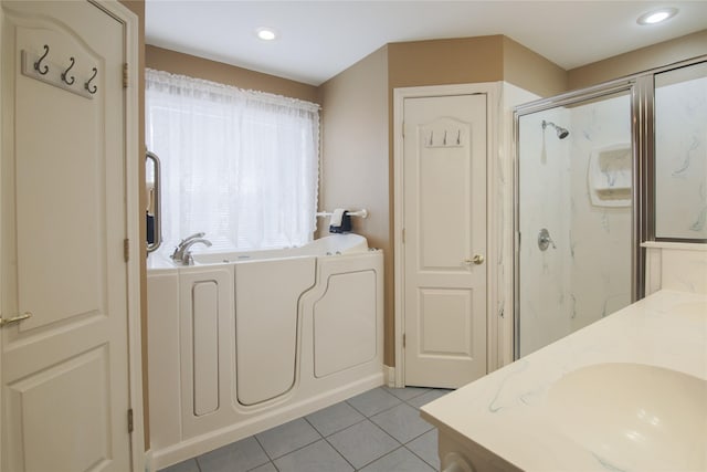 full bath featuring vanity, a marble finish shower, recessed lighting, tile patterned floors, and a garden tub