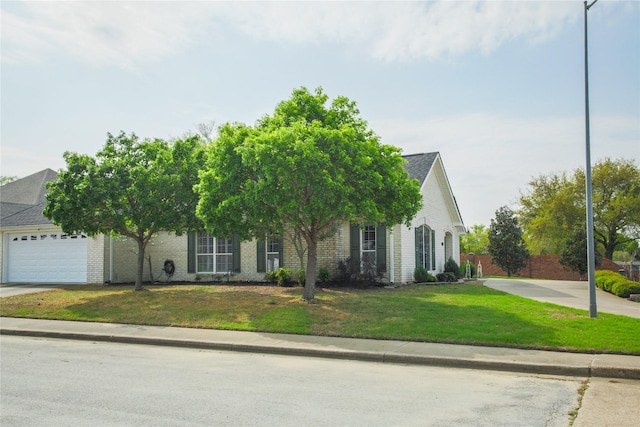 obstructed view of property featuring brick siding, a garage, a shingled roof, and a front yard