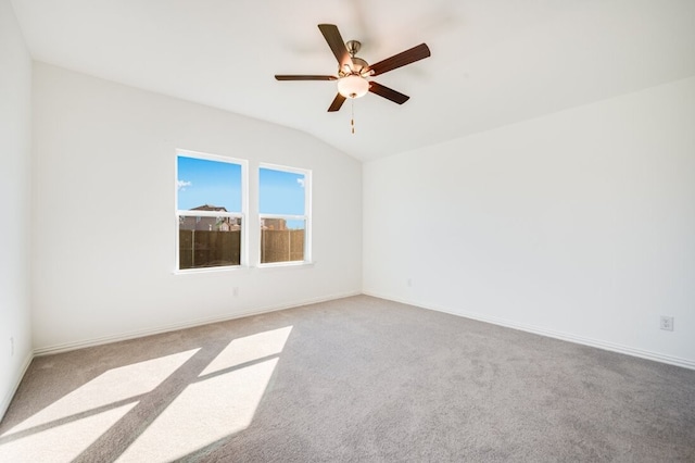carpeted empty room with baseboards, lofted ceiling, and ceiling fan