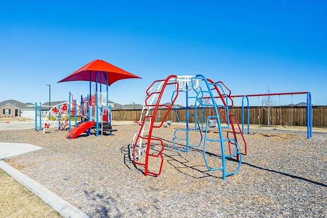 community jungle gym featuring fence