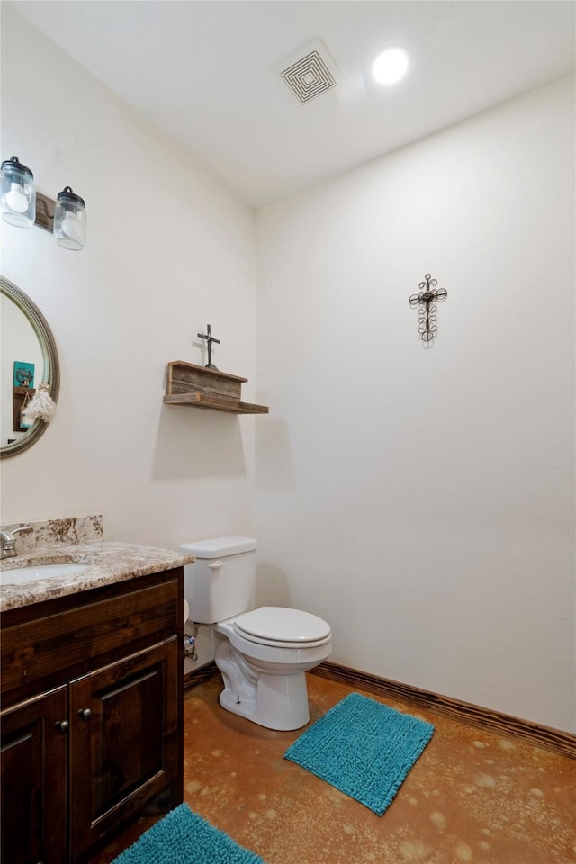 half bathroom featuring baseboards, visible vents, toilet, and vanity