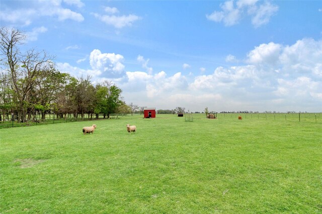 view of home's community featuring a lawn and a rural view