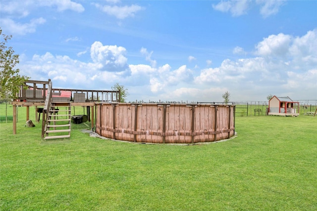 view of yard with an outdoor structure and fence