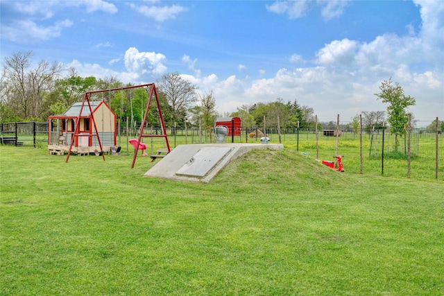 entry to storm shelter with fence and a yard