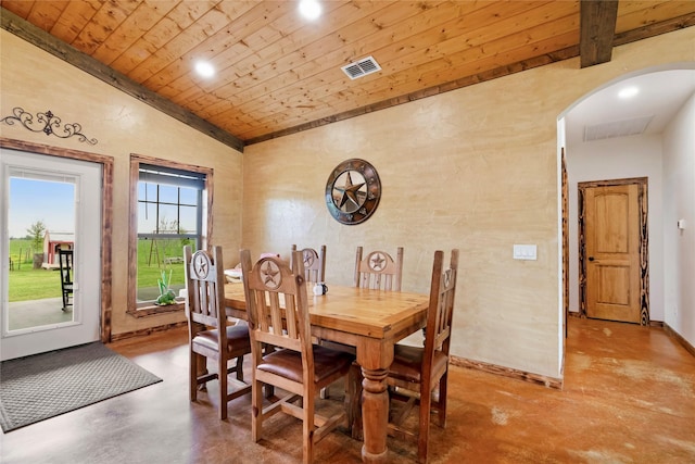 dining area with vaulted ceiling, concrete floors, wooden ceiling, arched walkways, and visible vents