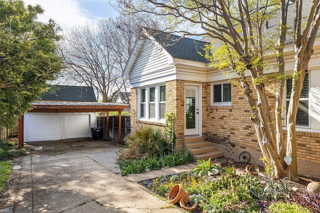 1936 Forest Park Blvd, Fort Worth, TX 76110 - view of front of property featuring brick siding, an outdoor structure, entry steps, concrete driveway, and a shingled roof