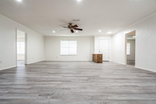 3100 E Park Blvd, Plano, TX 75074 - unfurnished living room featuring a ceiling fan, recessed lighting, wood finished floors, baseboards, and crown molding