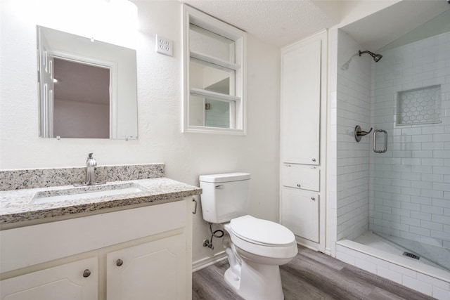 3100 E Park Blvd, Plano, TX 75074 - full bathroom featuring wood finished floors, vanity, a stall shower, and toilet