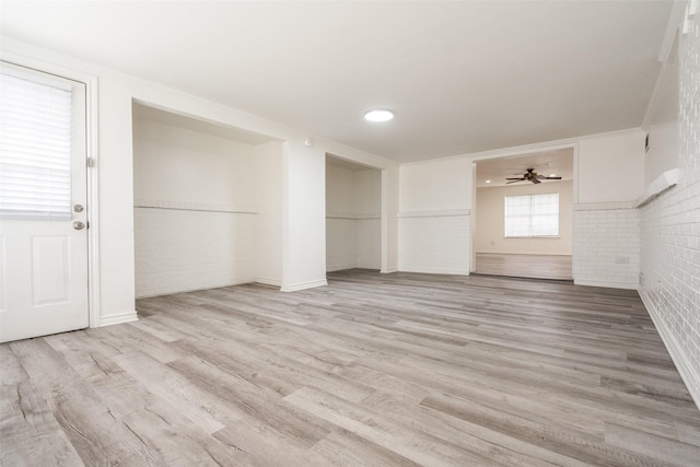 3100 E Park Blvd, Plano, TX 75074 - unfurnished living room featuring brick wall, light wood finished floors, and a ceiling fan