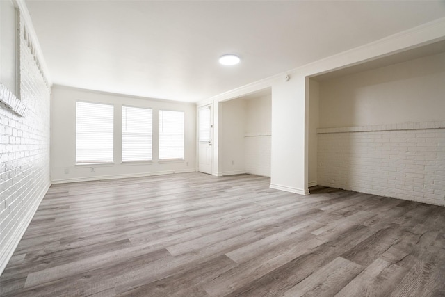 3100 E Park Blvd, Plano, TX 75074 - unfurnished bedroom featuring brick wall, wood finished floors, and baseboards