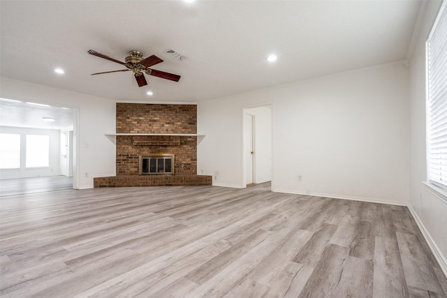 3100 E Park Blvd, Plano, TX 75074 - unfurnished living room featuring ceiling fan, light wood-style flooring, recessed lighting, a brick fireplace, and baseboards