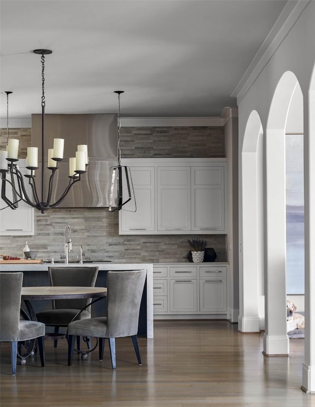 2205 Wheeler Dr, Southlake, TX 76092 - bar with tasteful backsplash, pendant lighting, a sink, and ornamental molding
