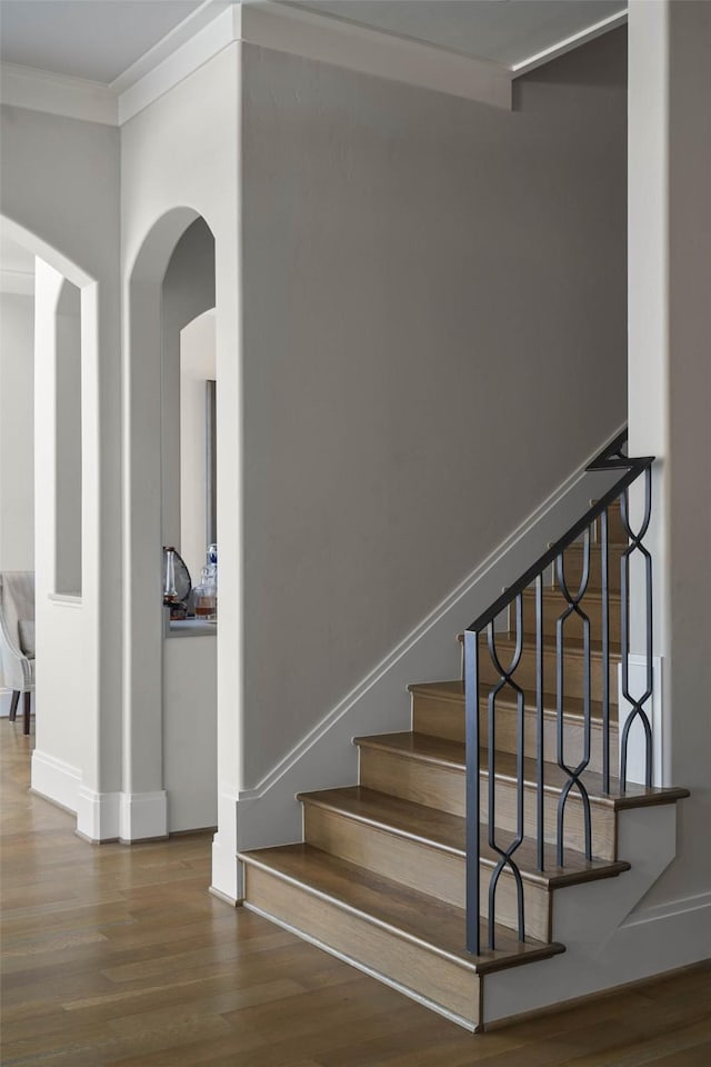 2205 Wheeler Dr, Southlake, TX 76092 - staircase with arched walkways, wood finished floors, ornamental molding, and baseboards
