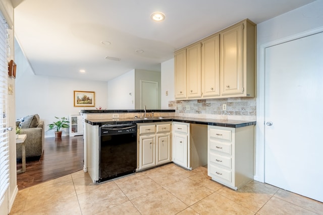 kitchen with a sink, cream cabinetry, dishwasher, and light tile patterned floors
