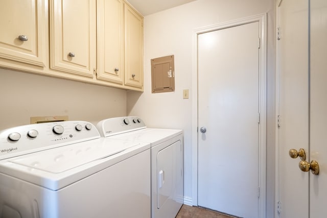clothes washing area with washing machine and clothes dryer and cabinet space