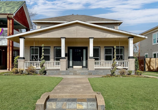 1217 Kings Hwy, Dallas, TX 75208 - view of front facade featuring a front lawn and covered porch